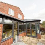A conservatory in a home with a table and chairs available for use as a Waterproofing for Conservatories in Westbury-On Severn.