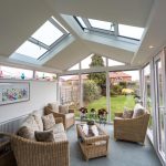 A conservatory with a glass roof and wicker furniture providing Waterproofing for Conservatories in Westbury-On Severn.