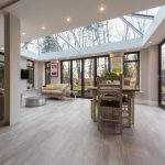 A spacious {living room} with a {glass roof}.